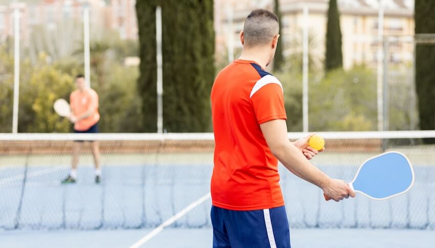 2 men playing pickleball