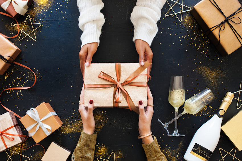 2 people holding a gift