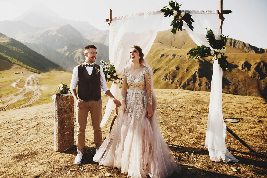 Small wedding ideas: A bride and groom in a remote, dramatic setting