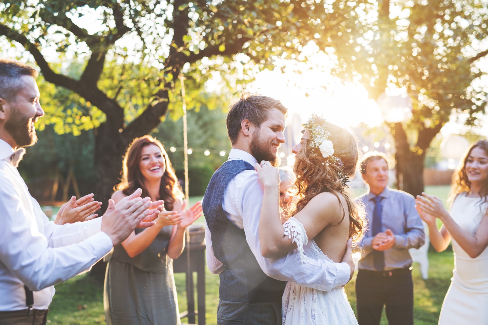 minimony: Newlywed couple dancing while surrounded by smiling guests