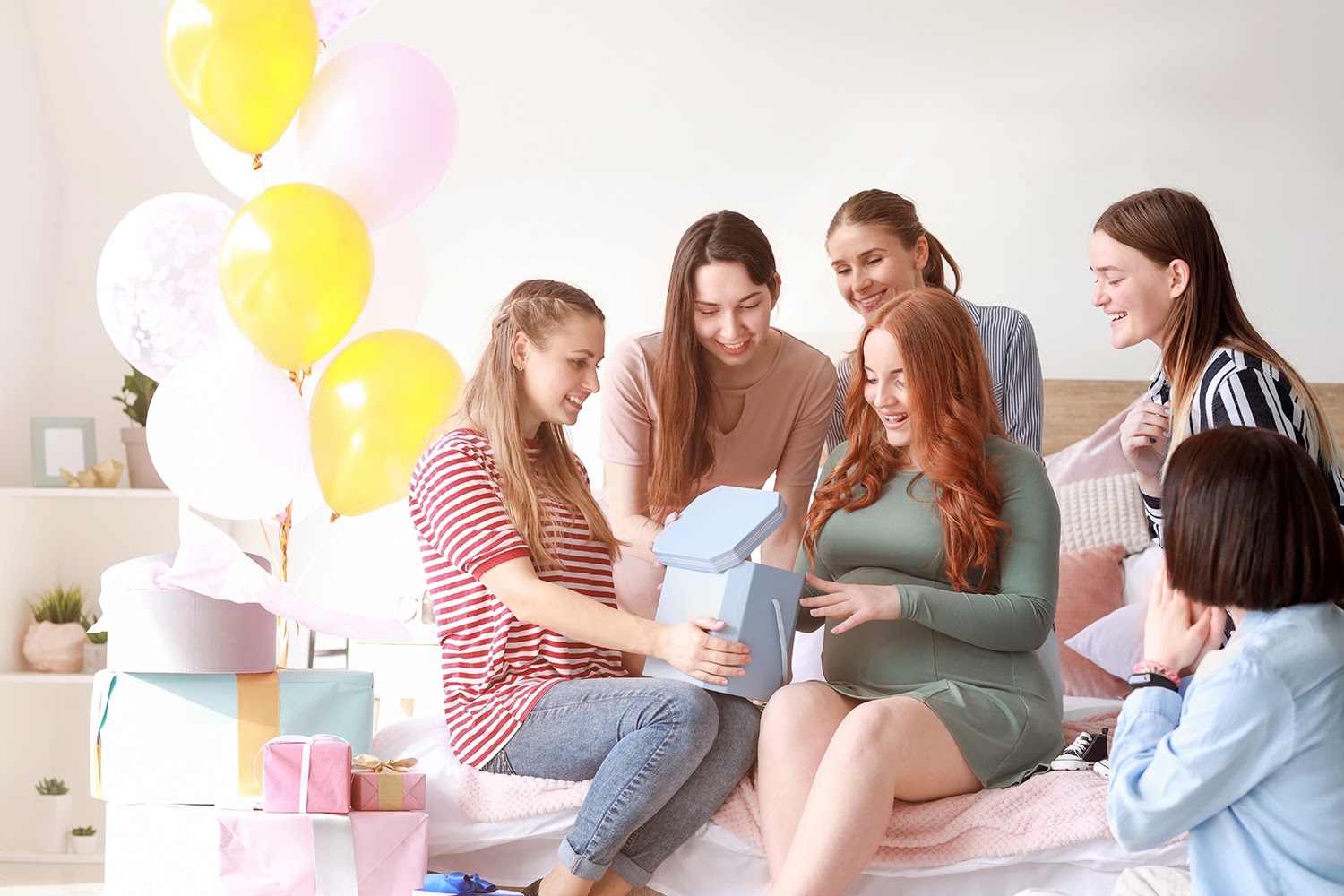 A group of women with gifts and balloons at a baby shower