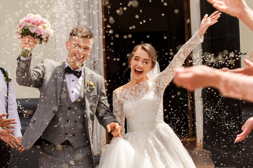 A couple gets rice thrown at them on their wedding day