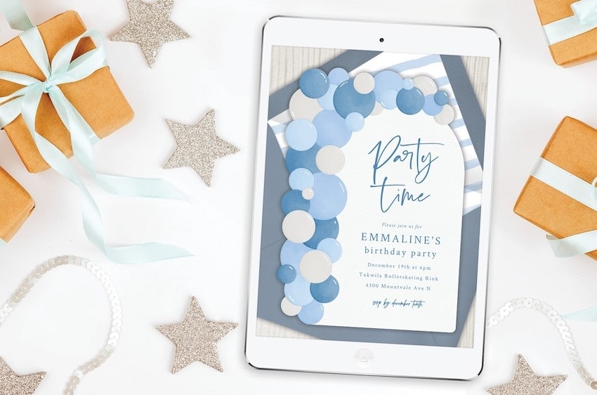 Winter party ideas: Balloon Arch Invitation on a tablet screen, small gifts, and star decorations