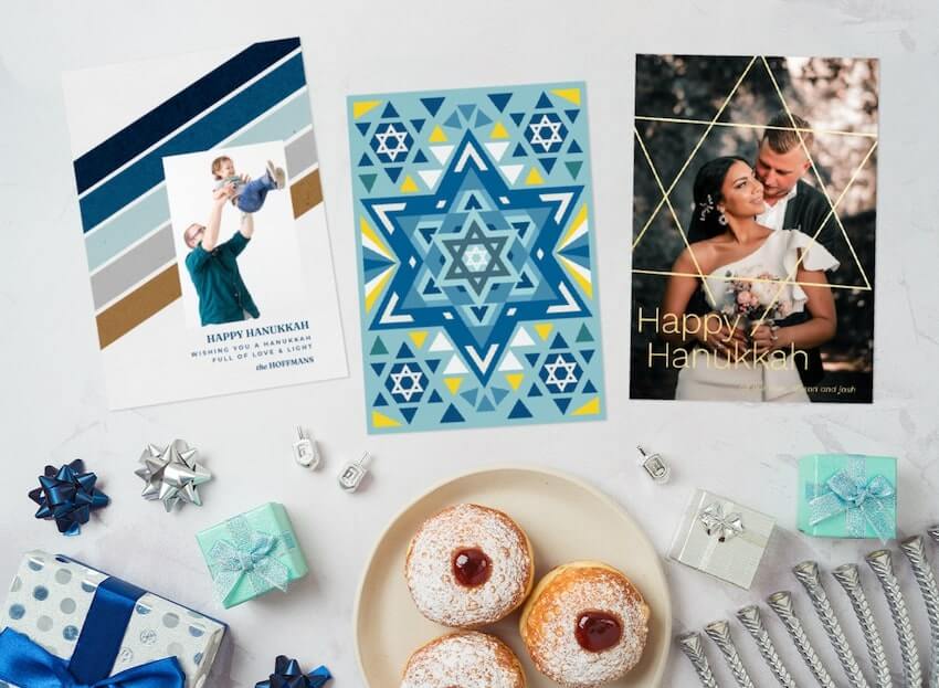 Hanukkah cards, small gifts, and food on a table