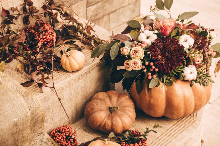fall wedding decorations: pumpkins with floral arrangements