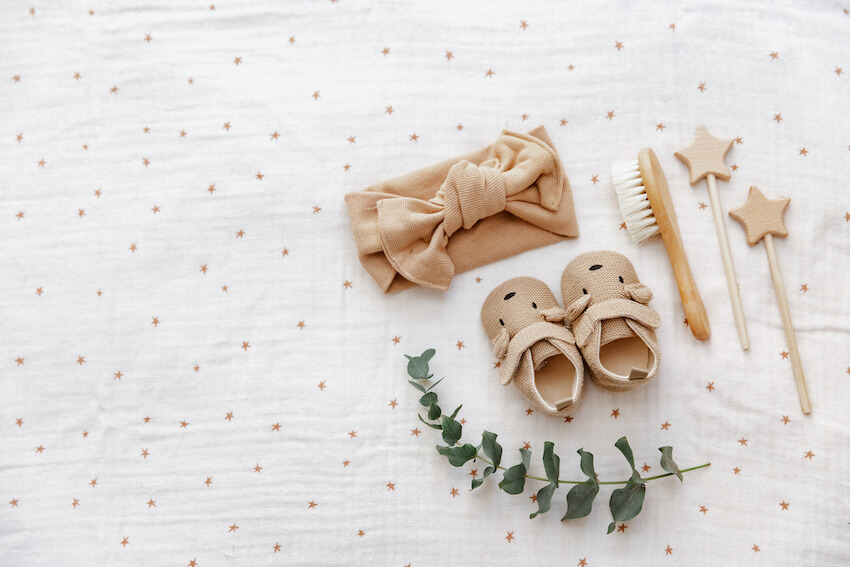 Gender neutral baby shower: baby shoes, brush, towel and stars