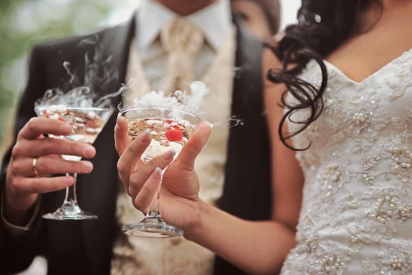Wedding reception ideas: bride and groom drinking cocktails