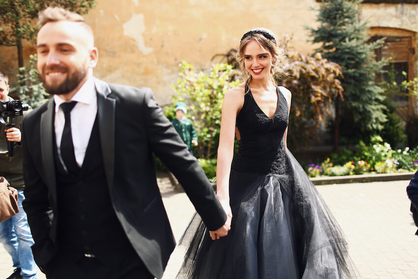 Bride and groom happily holding hands