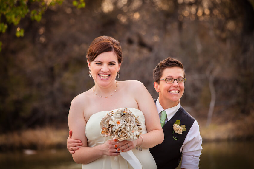 Bride and groom happily smiling at the camera