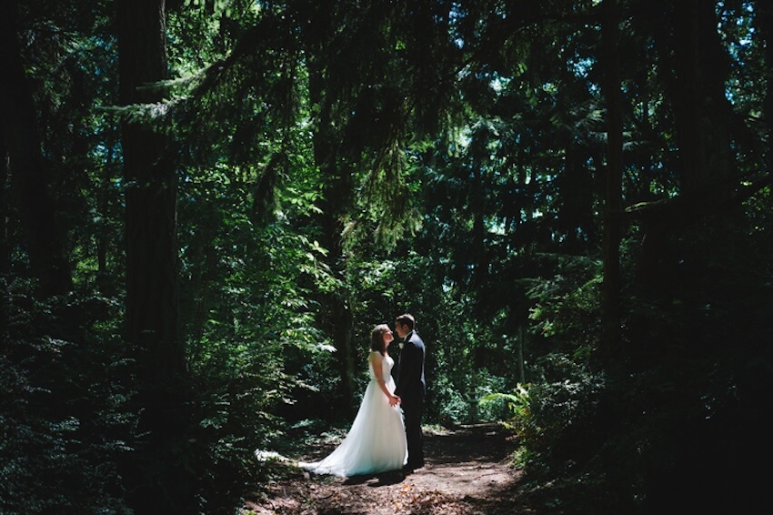 Green wedding: bride and groom having a photoshoot at a forest