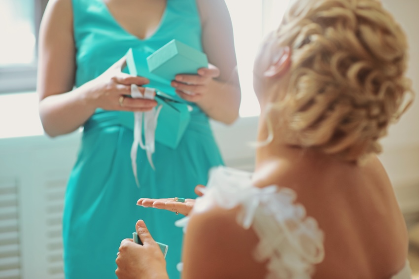 Bridesmaid gifts: bride holding a gift