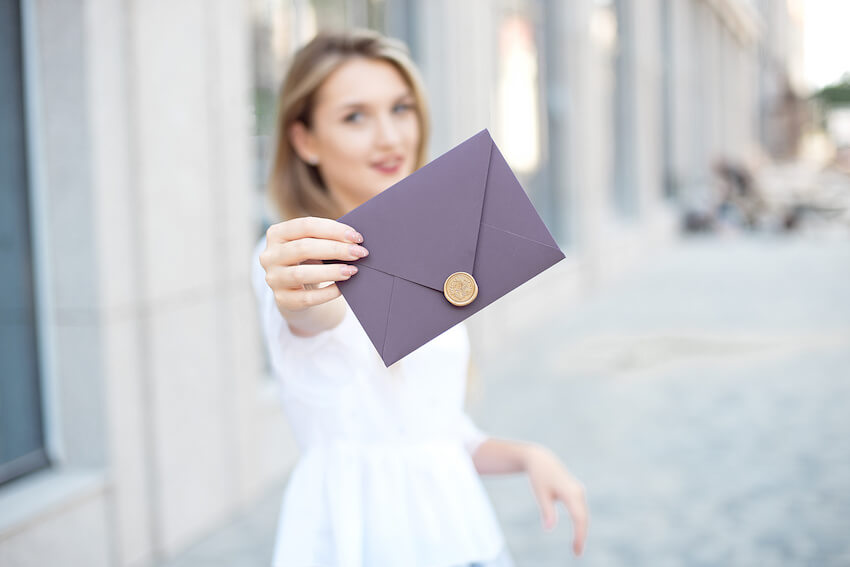 Will you be my bridesmaid: bride showing an invitation card