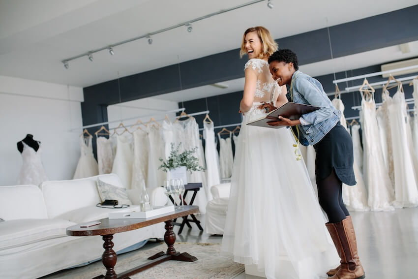 Wedding checklist: bride trying on her wedding dress