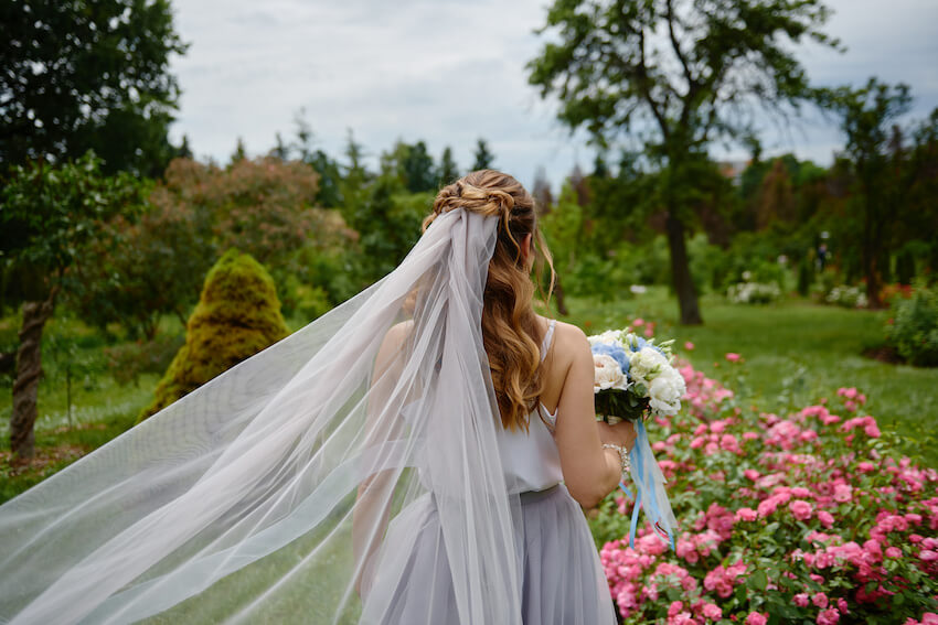 Bride walking in a garden