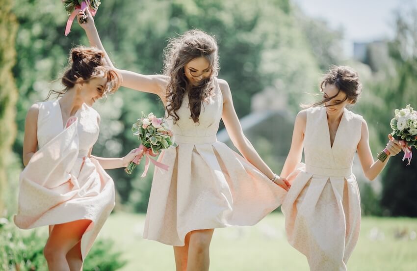 Bridesmaid proposal cards: bridesmaids happily walking while holding their bouquet