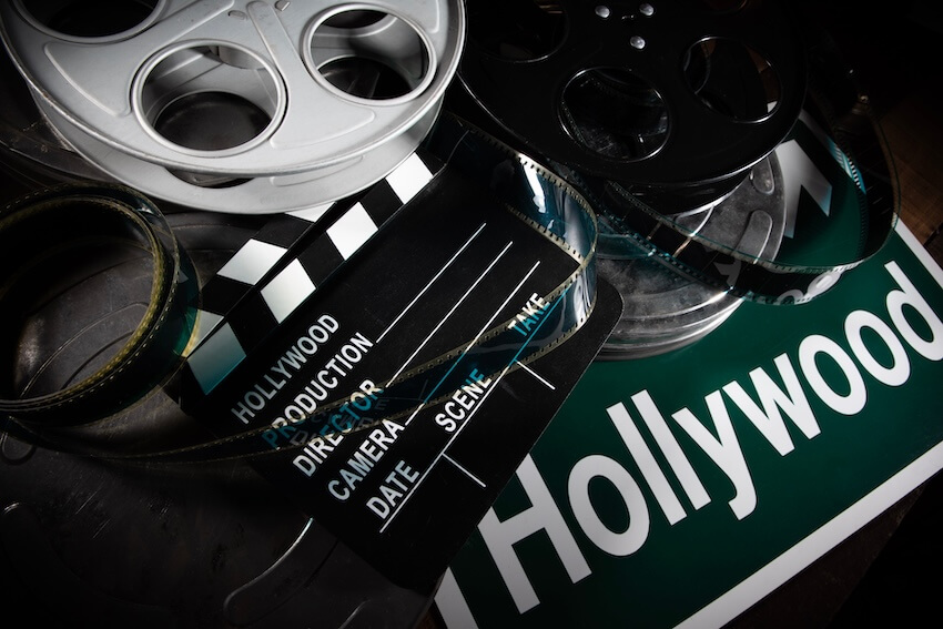 Old Hollywood theme party: clapperboard, 2 film reels, and a green sign with the word Hollywood on it