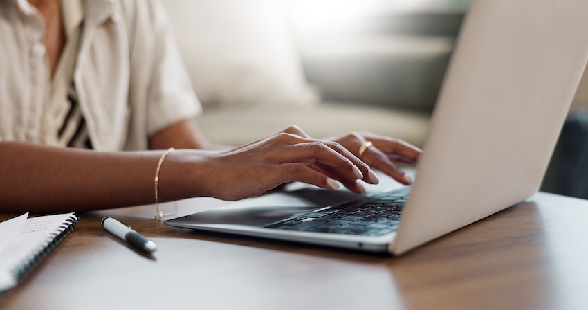 Digital thank you card: close up of a woman's hands using a laptop