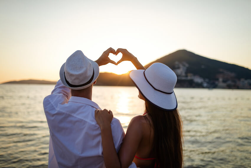 Couple doing a heart shape using their hands
