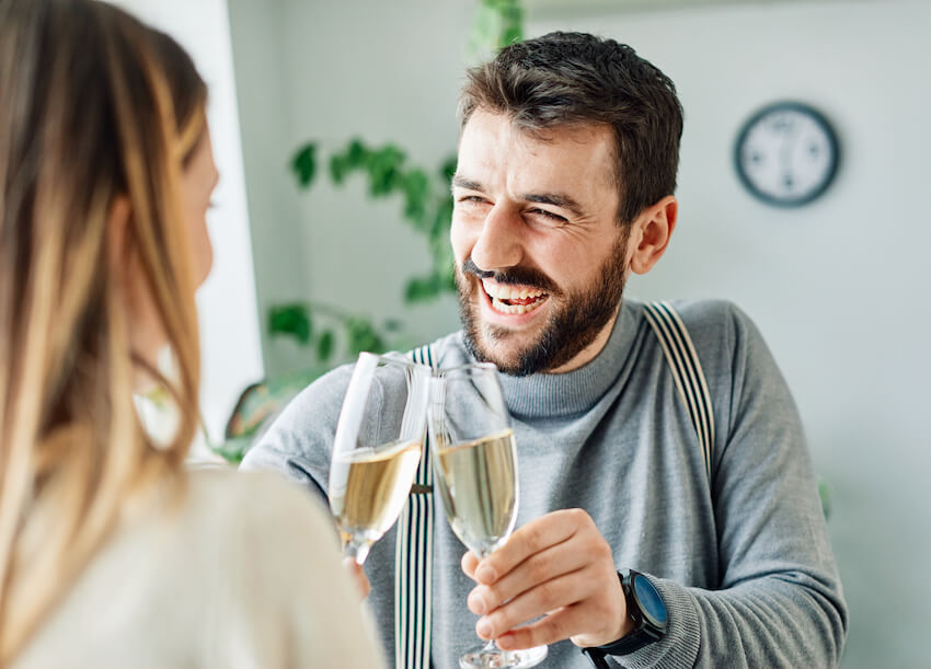 Happy birthday funny for him: couple happily having a toast