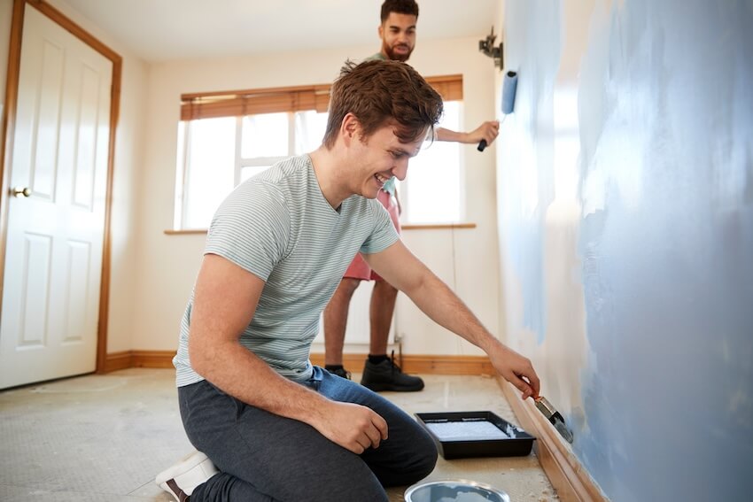 Two men painting a room