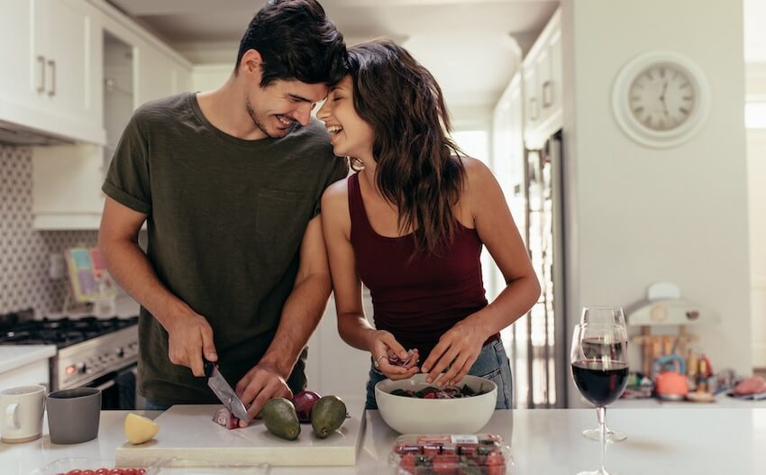 Couple happily preparing their food