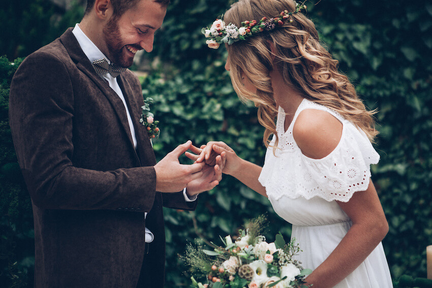 Boho wedding invitations: couple holding hands