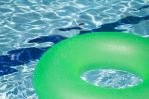 Pool party invitations: an inner tube floating in a pool