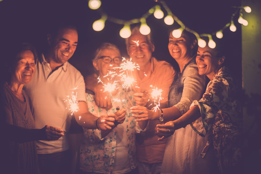 New Years greetings: family celebrating the New Year and holding some sparklers