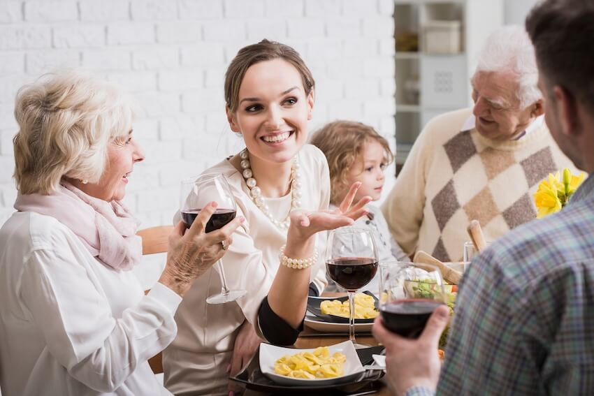 Happy birthday mother in law: family happily chatting while eating at home