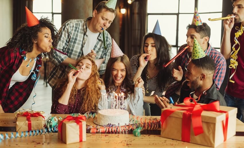 18th birthday wishes: friends blowing party horns at a birthday