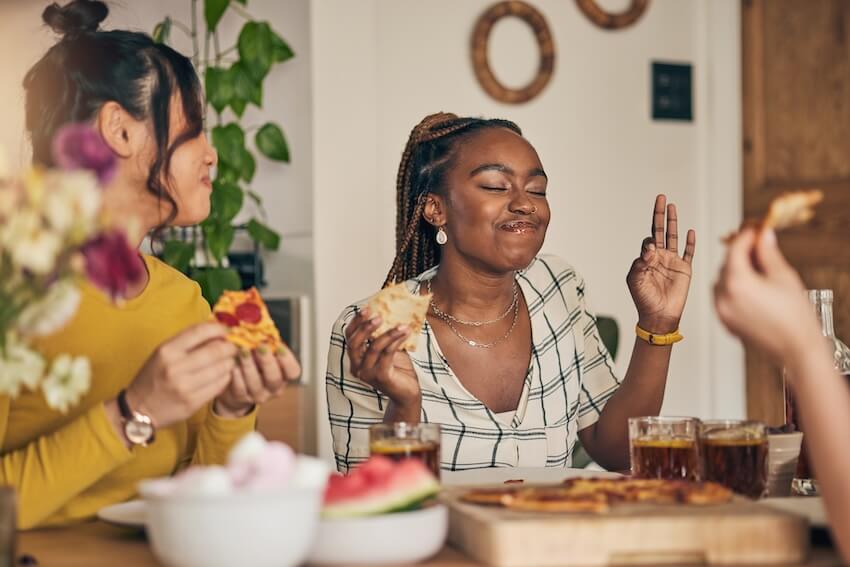 Things to do with friends at home: friends happily eating at home