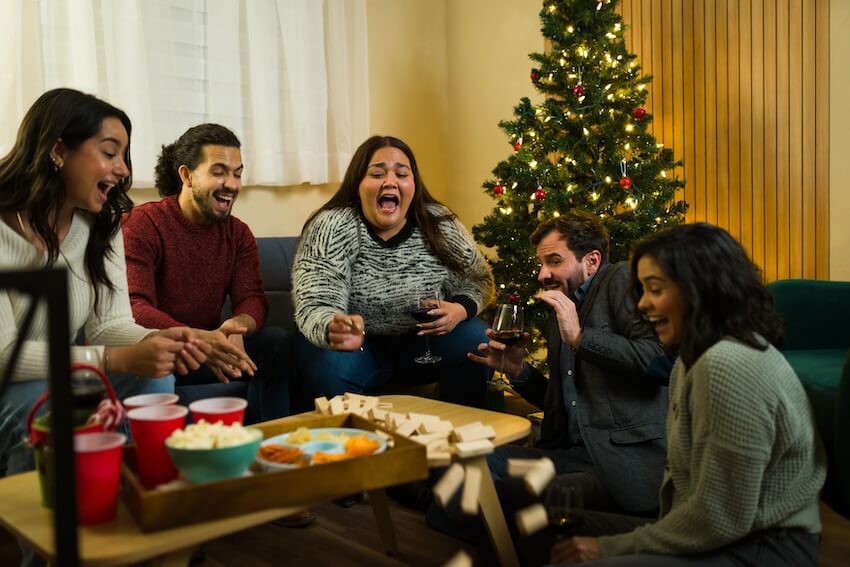 Friends happily playing Jenga