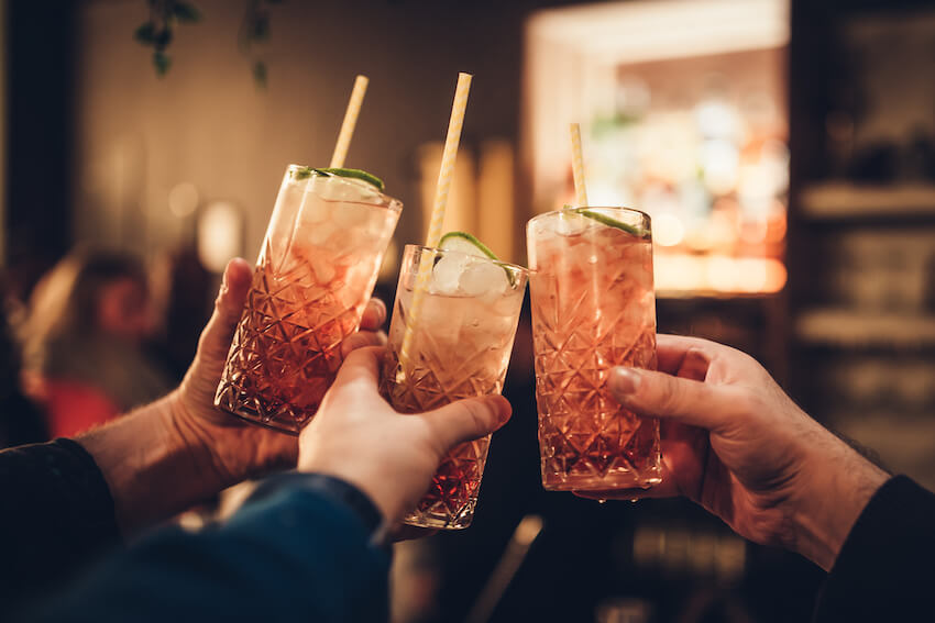 Cocktail party ideas: friends holding 3 cocktail glasses