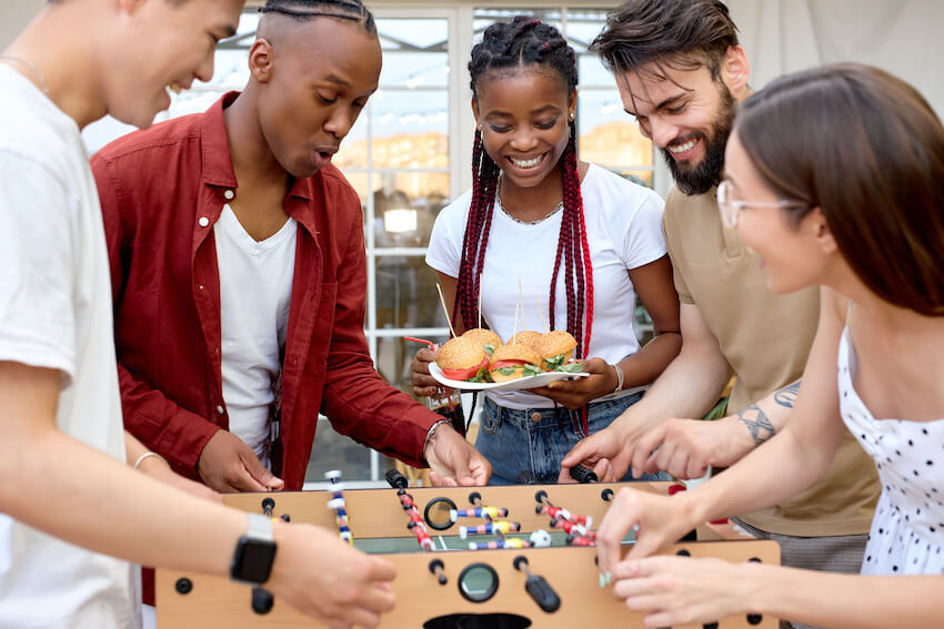 BBQ birthday party ideas for adults: friends playing table football