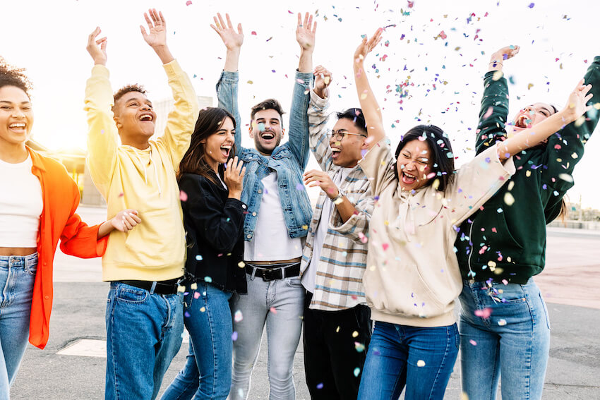 Friends throwing confetti up in the air