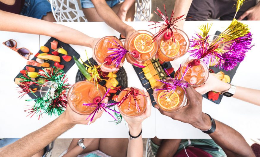 luau party: friends toasting at a luau