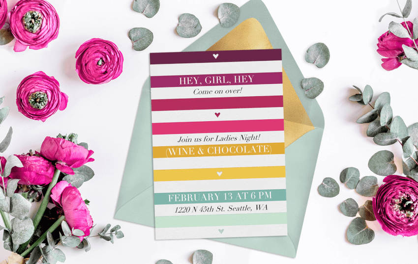Floral flatlay featuring Galentine's Day invitation