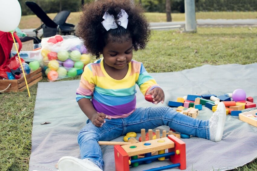 One happy camper birthday: girl playing outdoors