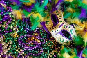 Masquerade party ideas: gold mask on green purple and gold beads