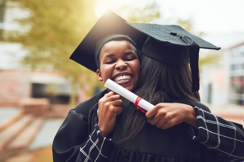 Sweet graduation messages: graduates happily hugging each other