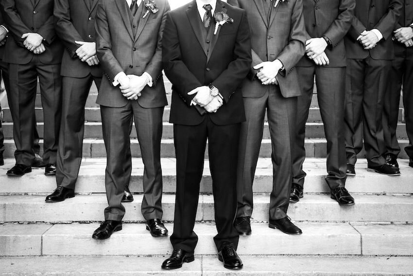 All black wedding: groom and groomsmen standing together