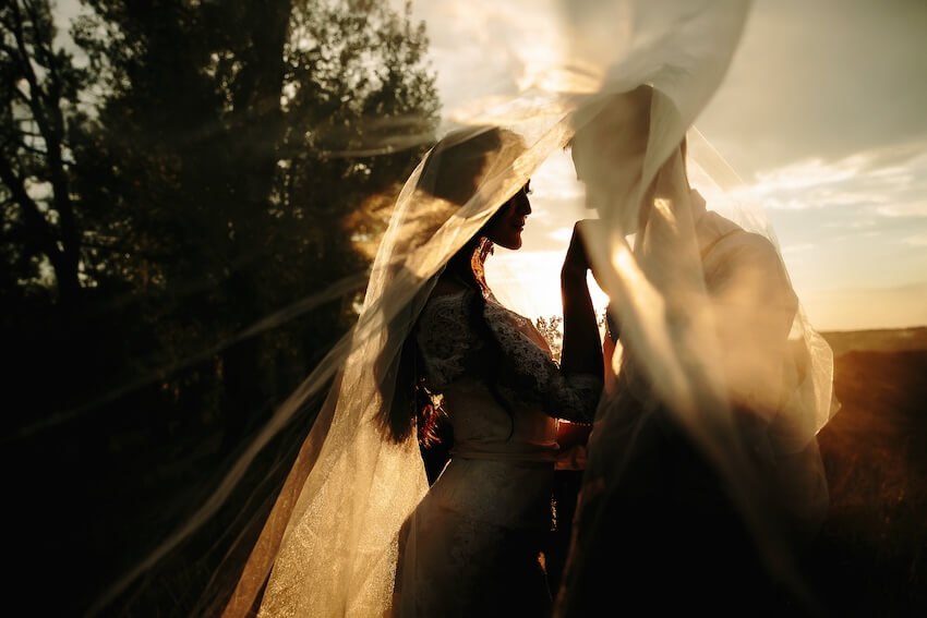 Groom kissing his bride's hand