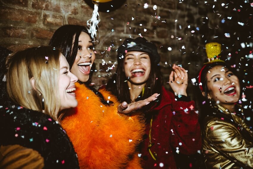17th birthday party ideas: group of friends at a party with confetti falling around them