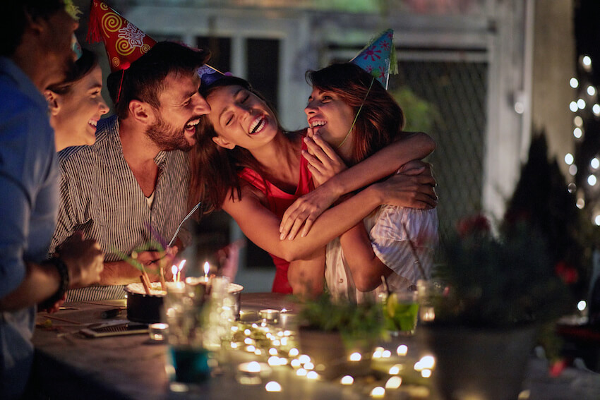Group of friends happily celebrating a birthday party