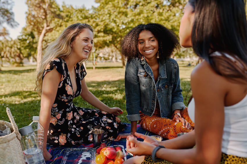 Picnic invitation: group of friends having a picnic