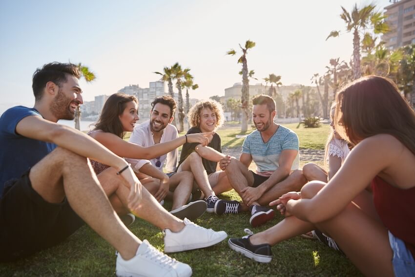 Group of friends sitting at a beach front park