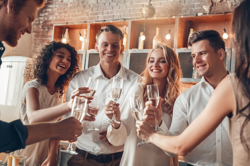 engagement party invitation wording: group of friends toasting with champagne
