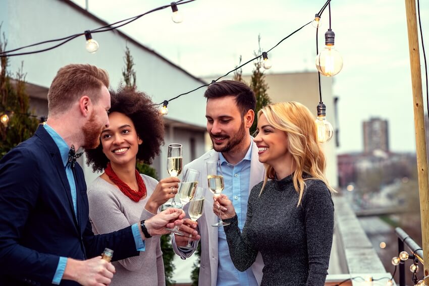 Going away party: group of people clinking their glasses