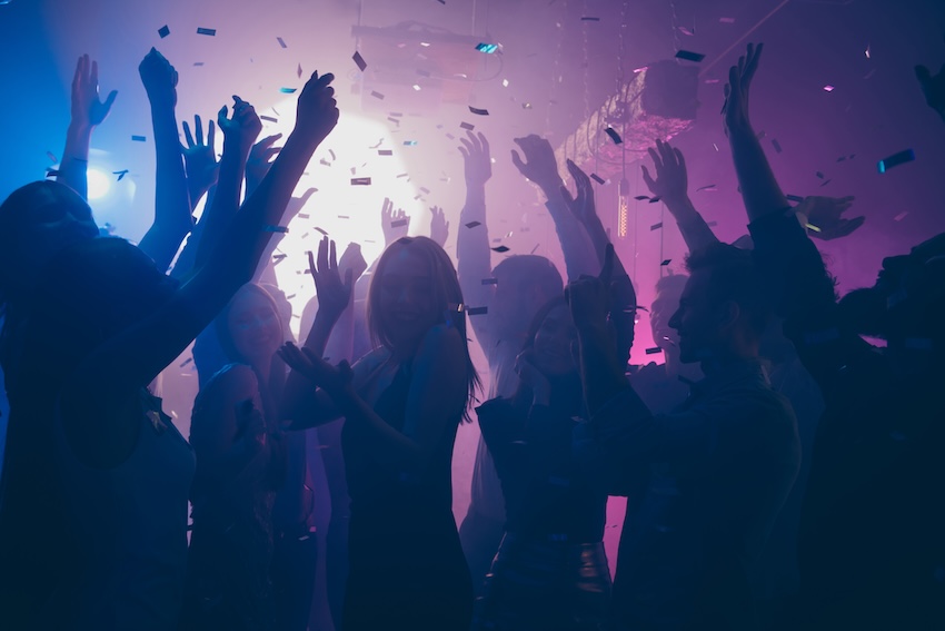 Neon party ideas: group of people dancing at a club