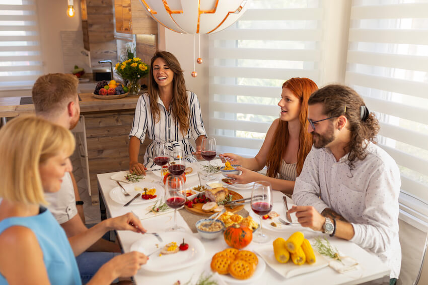 Thanksgiving potluck: group of people happily eating together